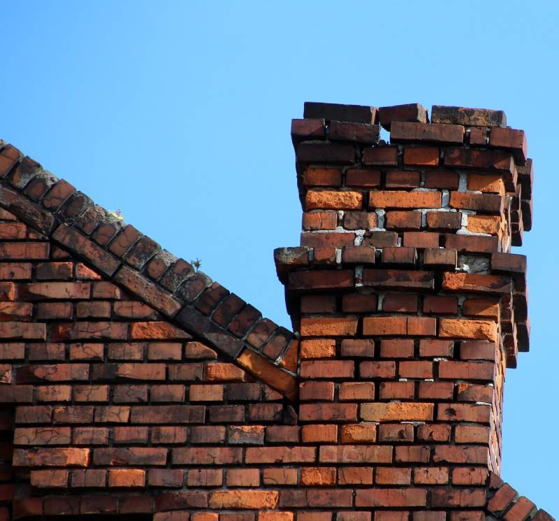 Signs Your Newbury Home Needs a Chimney Inspection Damaged chimney on an Newbury home showing cracks and missing mortar